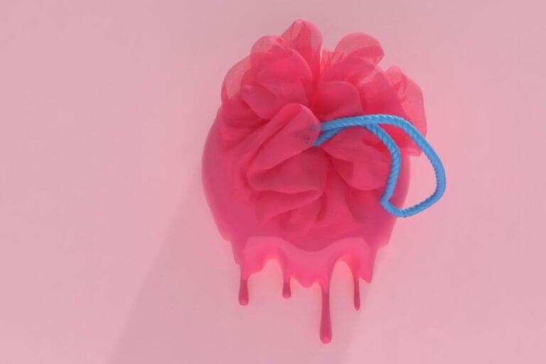 Symbolbild eines pinken Netzschwammes, aus dem pinke Flüssigkeit einen rosa Hintergrund herunterläuft - Meine Mariske, ein Erfahrungsbericht